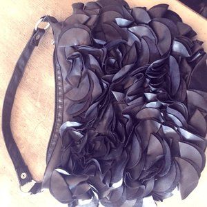 Black shoulder bag zips at top